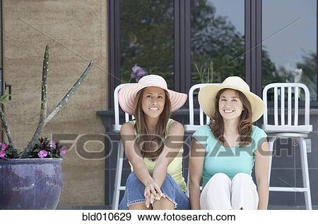 Stock Photo - Portrait of two women sitting together. Fotosearch