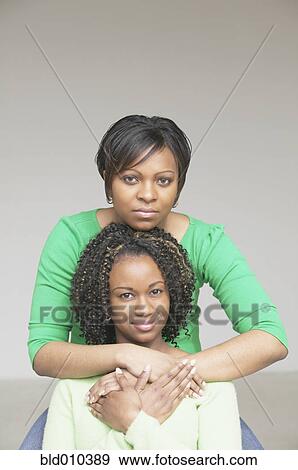 Portrait of two young women in a row View Large Photo Image Stock Photo - Portrait of two young women in a row. Fotosearch