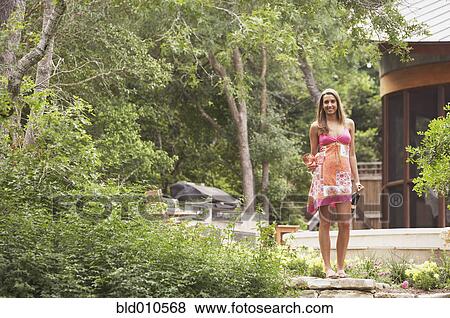 Portrait of woman holding wine bottle View Large Photo Image Stock Photo - Portrait of woman holding wine bottle. Fotosearch