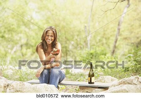 Stock Image - Portrait of woman holding wineglass. Fotosearch