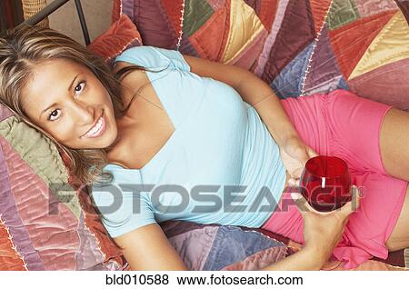 Portrait of woman holding wineglass View Large Photo Image Stock Photo - Portrait of woman holding wineglass. Fotosearch