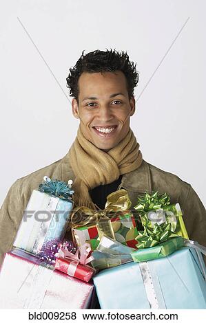 Portrait of young man with gifts View Large Photo Image Stock Photo - Portrait of young man with gifts. Fotosearch