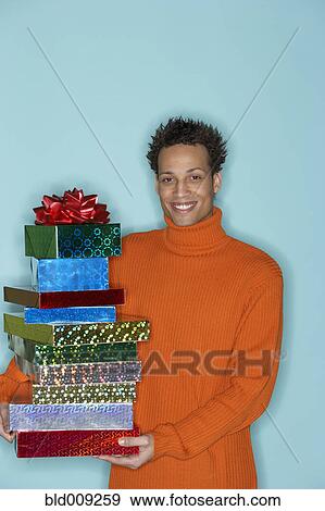 Portrait of young man with gifts View Large Photo Image Stock Photo - Portrait of young man with gifts. Fotosearch