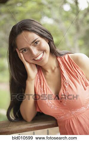 Stock Photo - Portrait of young woman smiling. Fotosearch