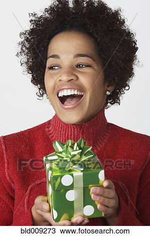 Portrait of young woman with gift View Large Photo Image Stock Image - Portrait of young woman with gift. Fotosearch