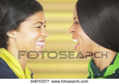 Profile of two women laughing View Large Photo Image Stock Photo - Profile of two women laughing. Fotosearch