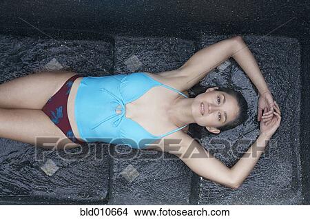 Reclining woman in swimwear View Large Photo Image Picture - Reclining woman in swimwear. Fotosearch