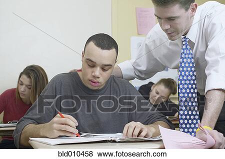 Stock Photo - Teacher and students in classroom. Fotosearch