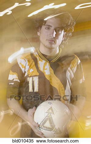 Stock Photography - Teenage boy holding soccer ball. Fotosearch