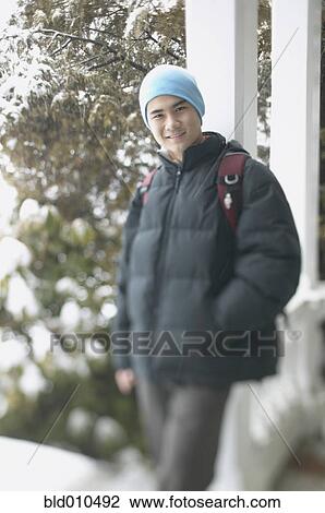 Stock Image - Teenage boy on a winter day. Fotosearch