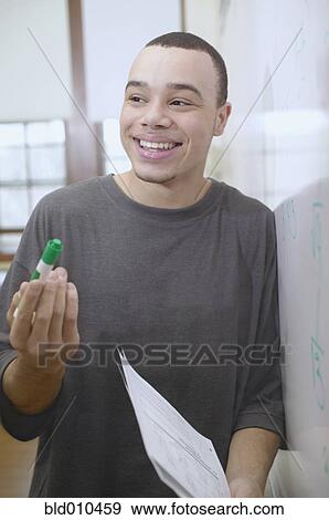 Stock Photo - Teenage boy standing near whiteboard. Fotosearch