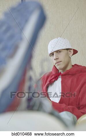 Stock Photo - Teenage boy wearing baseball cap. Fotosearch