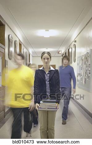 Stock Image - Teenage girl carrying books. Fotosearch