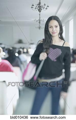 Stock Photograph - Teenage girl carrying shoulder bag. Fotosearch