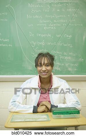 Stock Photography - Teenage girl sitting in classroom. Fotosearch