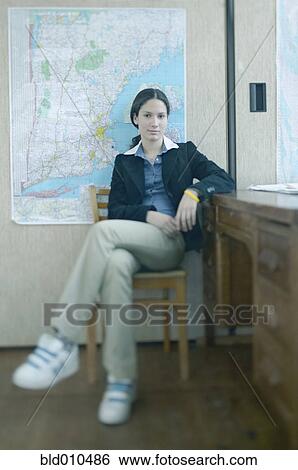 Teenage girl sitting in front of map View Large Photo Image Stock Photograph - Teenage girl sitting in front of map. Fotosearch