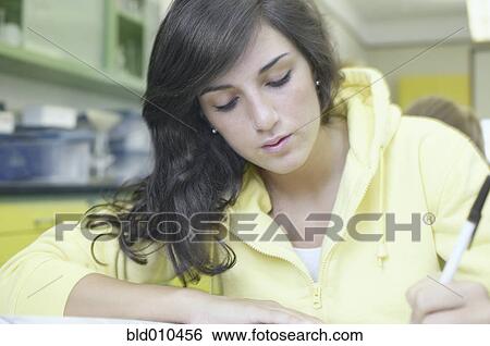 Stock Photograph - Teenage girl studying in a laboratory. Fotosearch