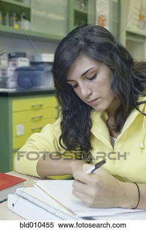 Stock Photography - Teenage girl studying in a laboratory. Fotosearch