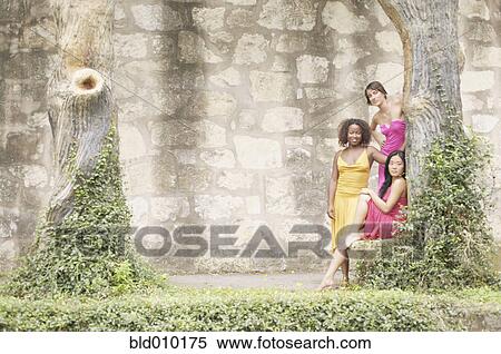 Three women next to ivy covered stone wall View Large Photo Image Stock Photography - Three women next to ivy covered stone wall. Fotosearch