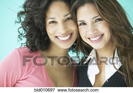 Stock Photo - Two women hugging and smiling. Fotosearch