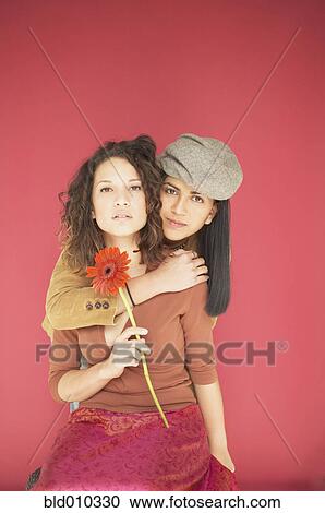 Two women hugging each other View Large Photo Image Stock Image - Two women hugging each other. Fotosearch