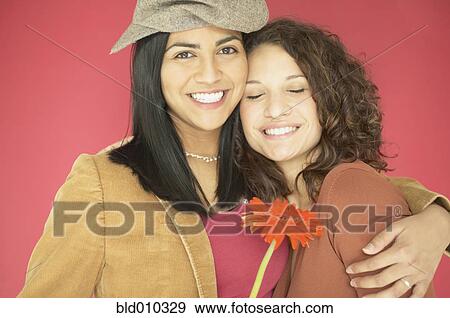 Two women hugging each other View Large Photo Image Stock Photo - Two women hugging each other. Fotosearch