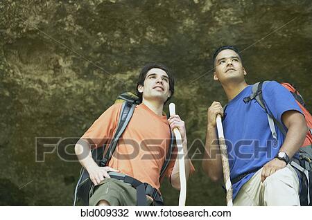 Stock Image - Two young men hiking in the forest. Fotosearch