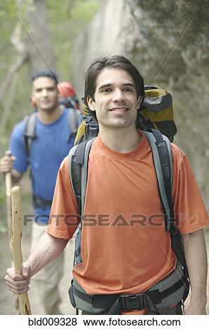 Two young men hiking in the forest View Large Photo Image Stock Photo - Two young men hiking in the forest. Fotosearch