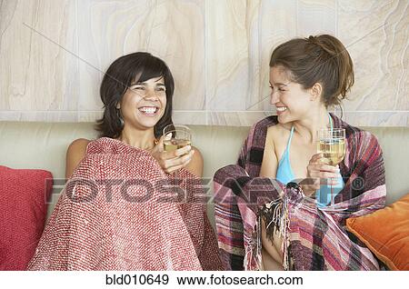 Stock Photo - Two young women holding wineglasses. Fotosearch