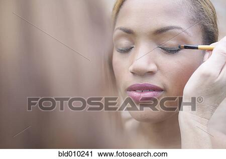 Woman applying eyeliner View Large Photo Image Stock Image - Woman applying eyeliner. Fotosearch