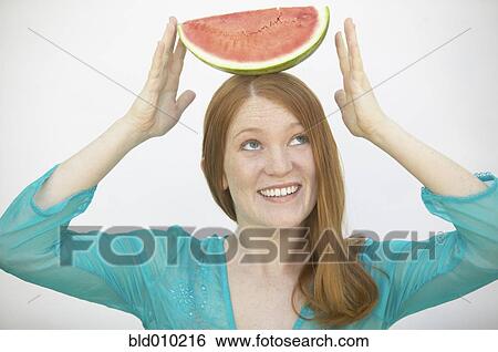 Woman balancing watermelon on her head View Large Photo Image Stock Photograph - Woman balancing watermelon on her head. Fotosearch
