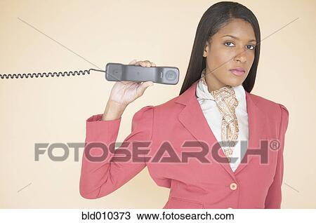 Woman holding a telephone receiver View Large Photo Image Stock Image - Woman holding a telephone receiver. Fotosearch