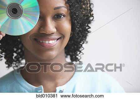 Woman holding compact disk View Large Photo Image Stock Image - Woman holding compact disk. Fotosearch