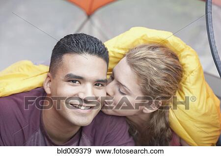 Woman kissing man in a tent View Large Photo Image Stock Photo - Woman kissing man in a tent. Fotosearch