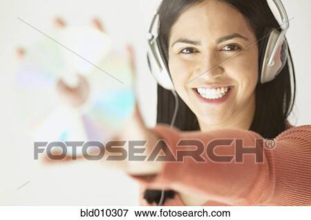 Stock Photo - Woman listening to music with headphones. Fotosearch