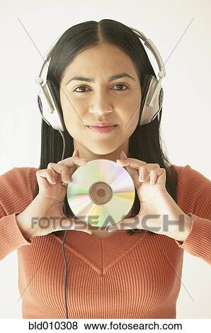 Stock Photo - Woman listening to music with headphones. Fotosearch
