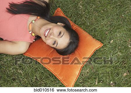 Woman outside lying on pillow View Large Photo Image Stock Photograph - Woman outside lying on pillow. Fotosearch