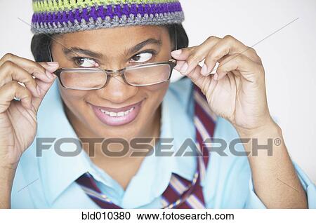 Woman peering over eyeglasses View Large Photo Image Stock Image - Woman peering over eyeglasses. Fotosearch