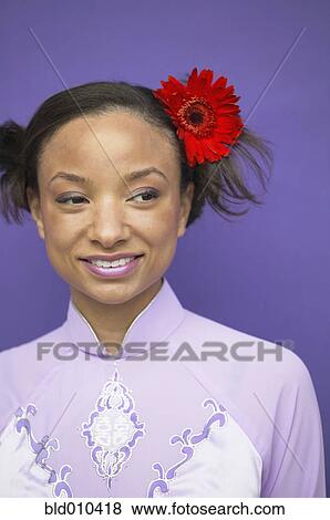 Woman wearing flower in hair View Large Photo Image Stock Photo - Woman wearing flower in hair. Fotosearch