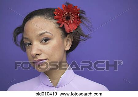 Woman wearing flower in hair View Large Photo Image Stock Photo - Woman wearing flower in hair. Fotosearch
