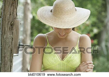 Woman wearing straw hat View Large Photo Image Stock Photo - Woman wearing straw hat. Fotosearch