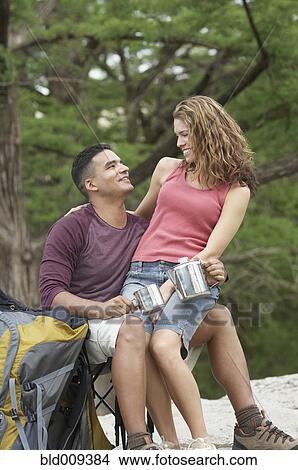 Picture - Young camping couple in a forest. Fotosearch