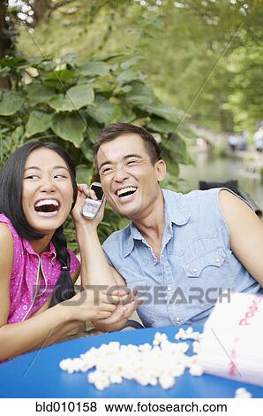 Young couple eating popcorn View Large Photo Image Stock Photo - Young couple eating popcorn. Fotosearch