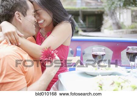 Stock Photo - Young couple embracing on a boat. Fotosearch