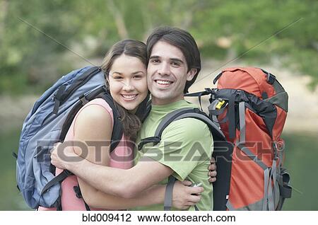Stock Image - Young couple embracing outdoors. Fotosearch