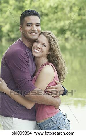 Young couple embracing outside View Large Photo Image Picture - Young couple embracing outside. Fotosearch