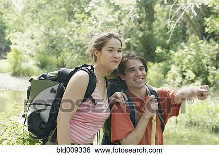Young couple enjoying the outdoors View Large Photo Image Stock Photograph - Young couple enjoying the outdoors. Fotosearch