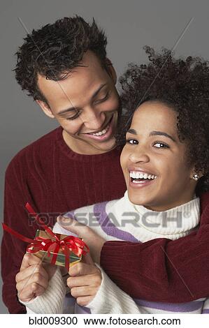 Young couple with gift View Large Photo Image Stock Image - Young couple with gift. Fotosearch
