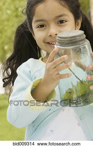 Picture - Young girl showing captured bug. Fotosearch