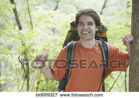 Young man backpacking in forest View Large Photo Image Stock Photo - Young man backpacking in forest. Fotosearch